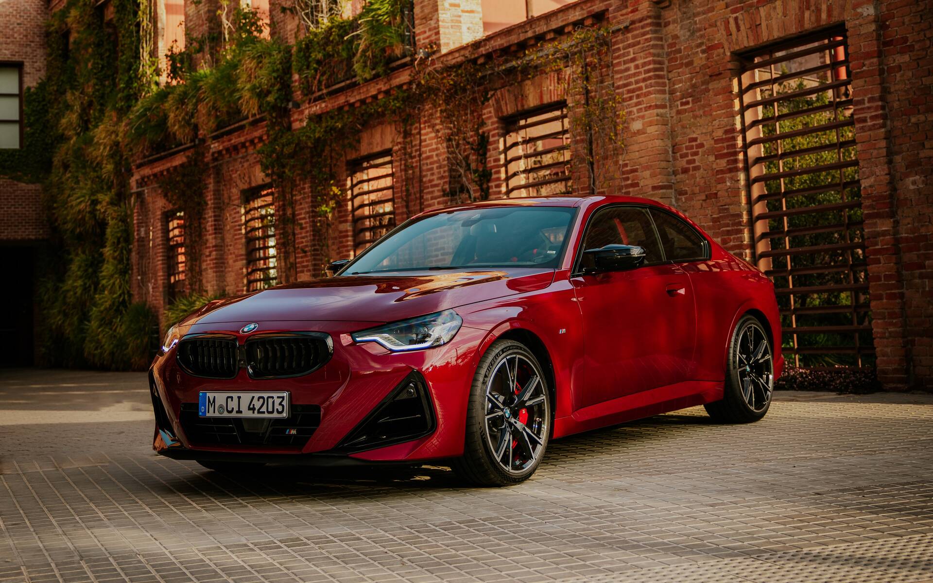 Metal BMW‑branded fastener on workbench, symbolizing engineering precision and performance of the M2 xDrive G87