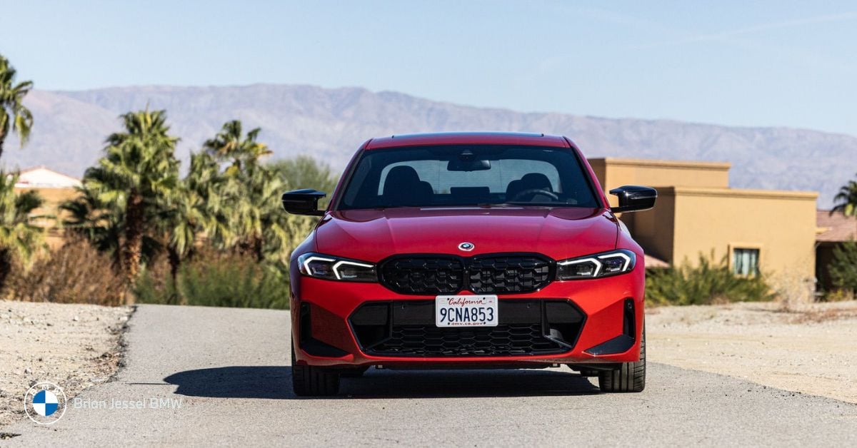BMW 3 Series front view on a scenic road, highlighting sporty performance and comfortable design