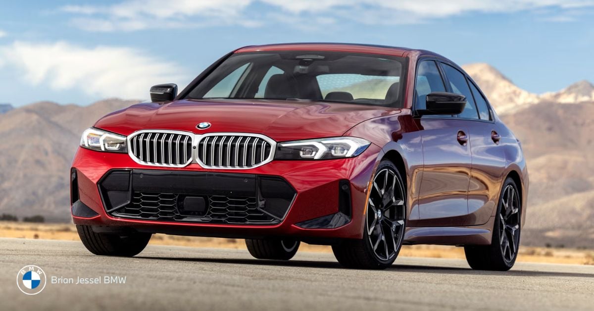 A red BMW 3 Series sedan parked outdoors with mountains behind, highlighting its sporty compact design