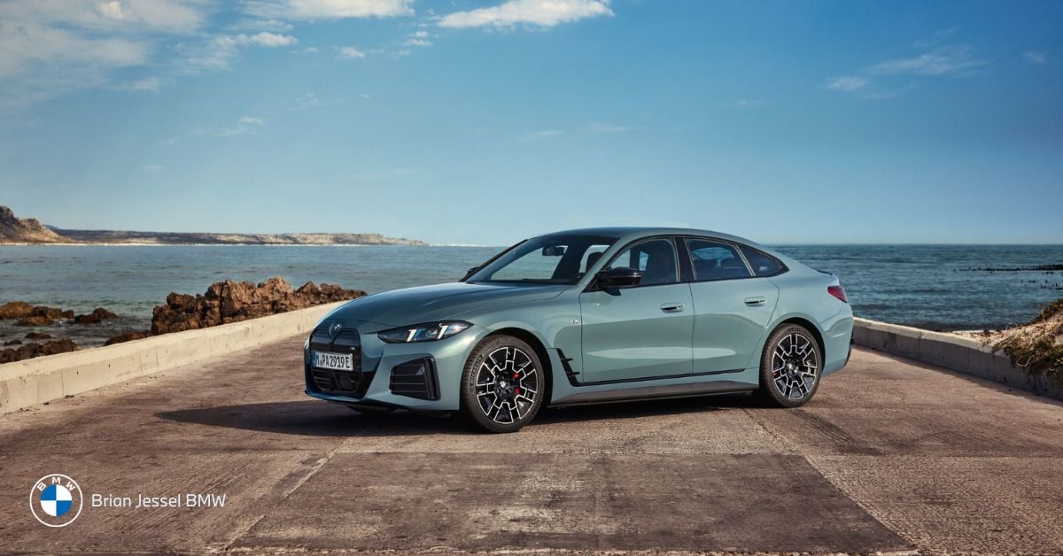 BMW i4 parked by the coast, showcasing its sleek design and sporty performance for scenic drives