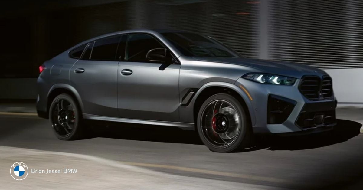 BMW X6 drives through city streets, showcasing coupe-inspired midsize SUV design, power, and modern luxury presence.
