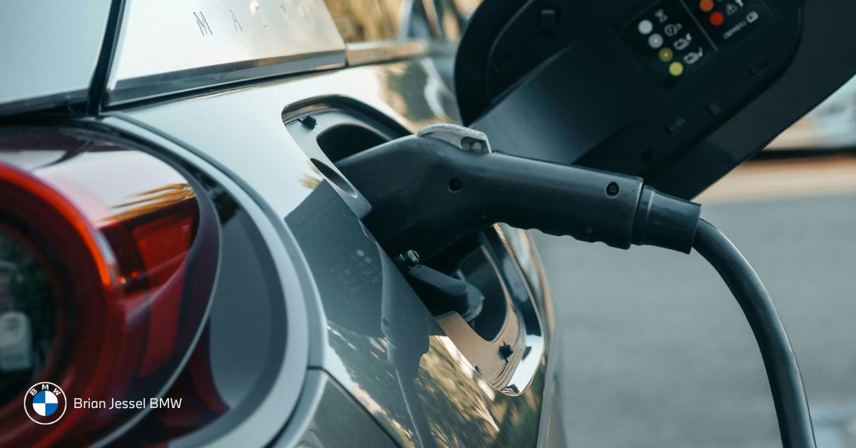 Electric vehicle plugged into charging station at Vancouver shopping center parking area during daytime hours