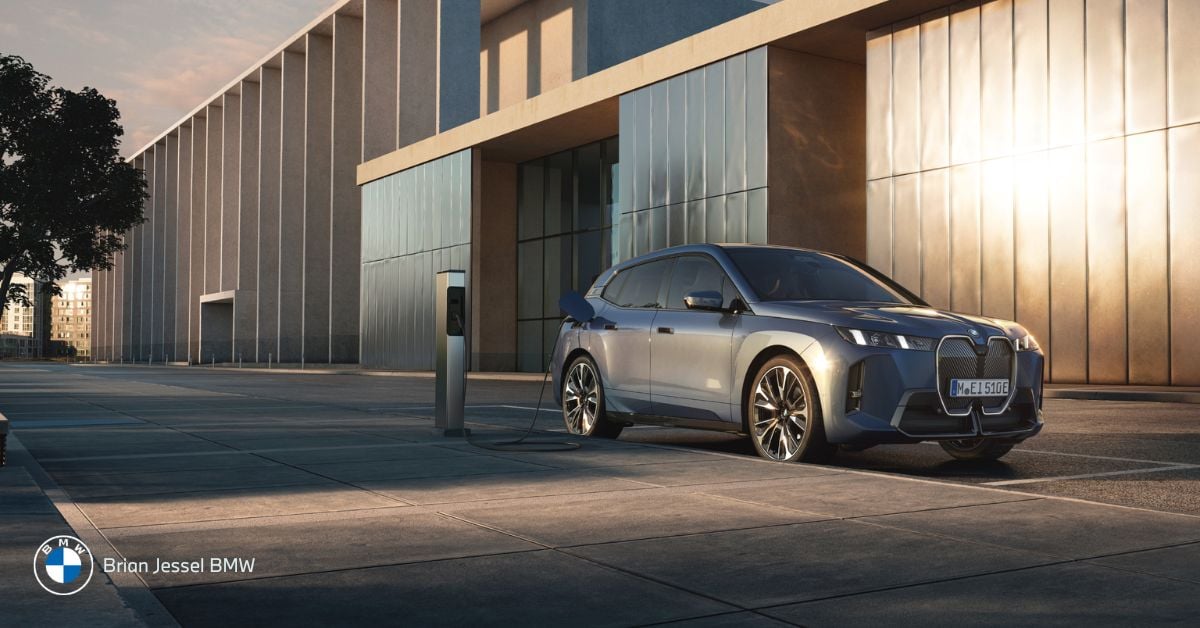 Electric vehicle charging at a modern station outside a contemporary building, illustrating how EV charging works in Vancouver