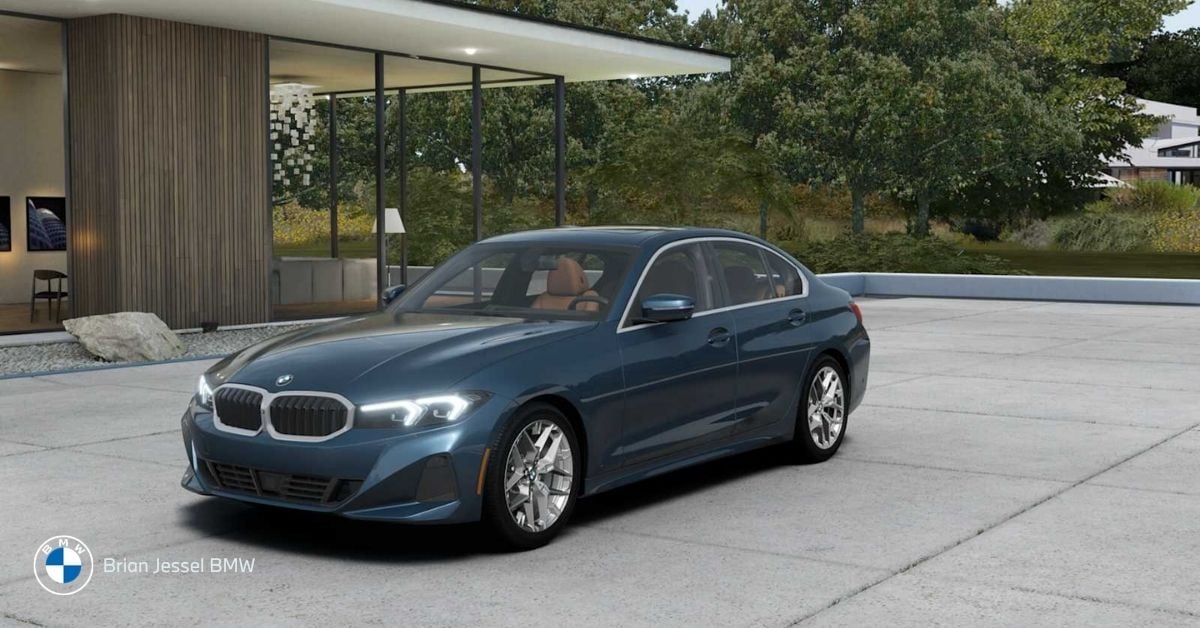 Blue BMW 3 Series xDrive parked, front-side view, luxury all-wheel-drive sedan, winter-ready, precise handling, wet-weather capable.