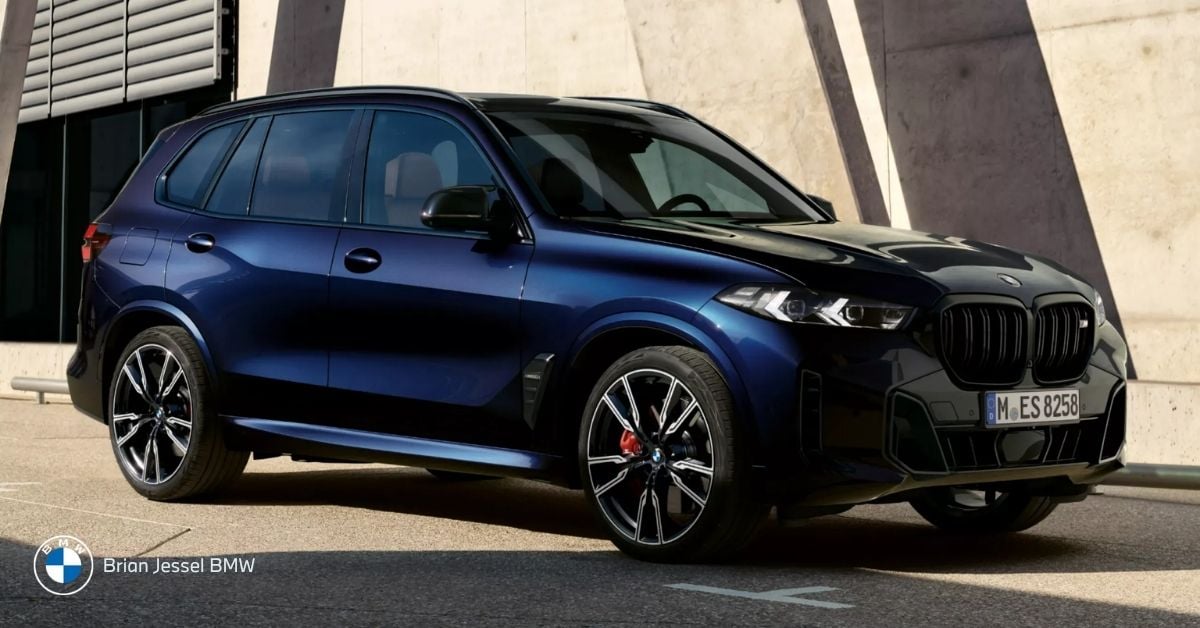 Dark blue BMW X5 xDrive parked, side-front view, luxury all-wheel-drive SUV, spacious, winter-capable, high ground clearance.