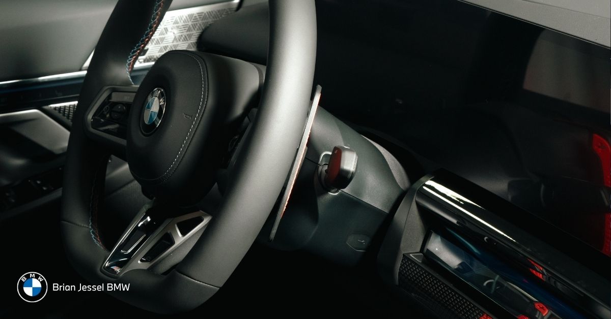 BMW iDrive display and steering controls inside 2026 BMW cabin designed for navigation, traffic updates, and daily commuting.