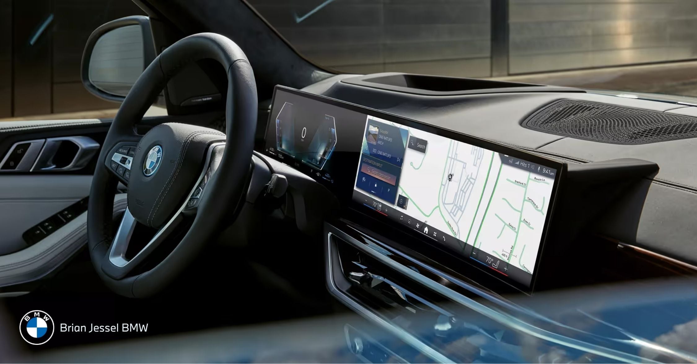 Modern BMW interior showcasing advanced driver assistance systems with large digital dashboard and navigation display