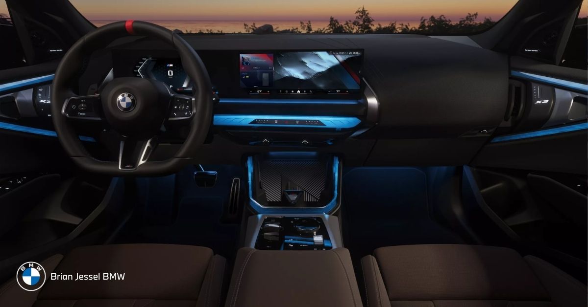 2026 BMW X3 interior featuring BMW Operating System 9 with curved display, digital controls, ambient lighting, and navigation interface.