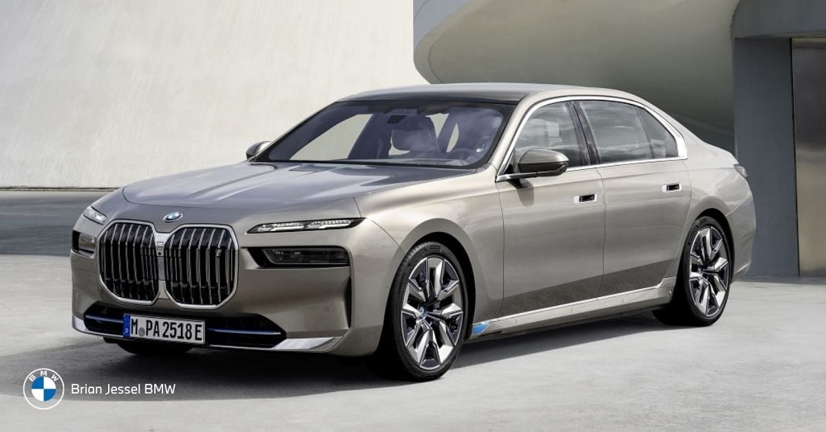 BMW 7 Series sedan parked outside modern building, showcasing luxury design and executive presence for premium client transportation