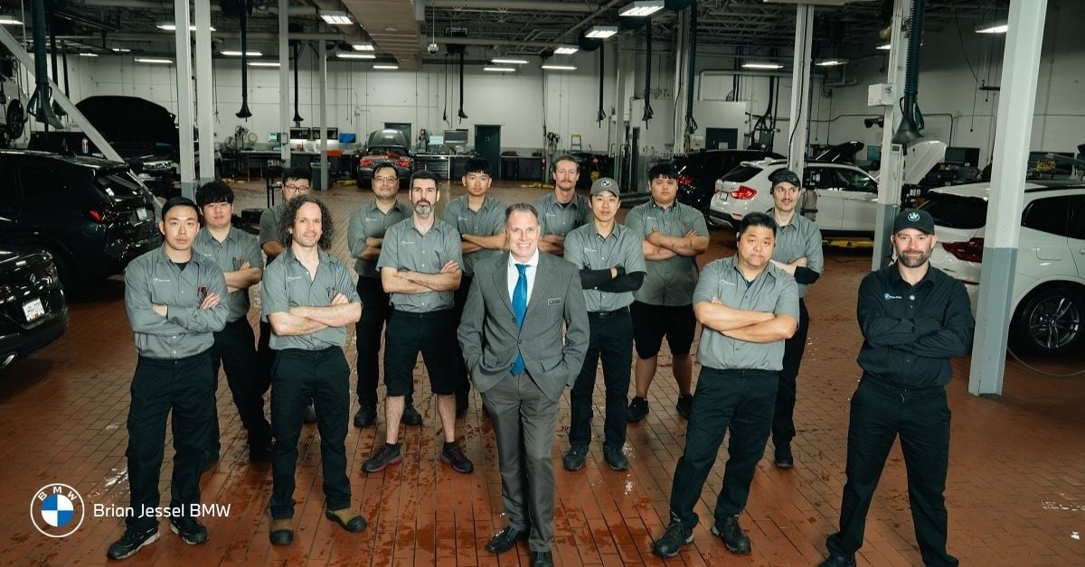BMW service team standing in dealership workshop in Vancouver, representing certified technicians, support, and trusted BMW service experience