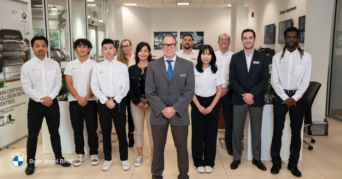 Brian Jessel BMW team standing in dealership showroom in Vancouver, representing customer support, sales expertise, and vehicle guidance for buyers