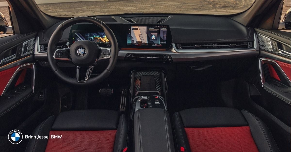 BMW interior dashboard with infotainment display and controls, representing ownership costs including financing, insurance, fuel, maintenance expenses