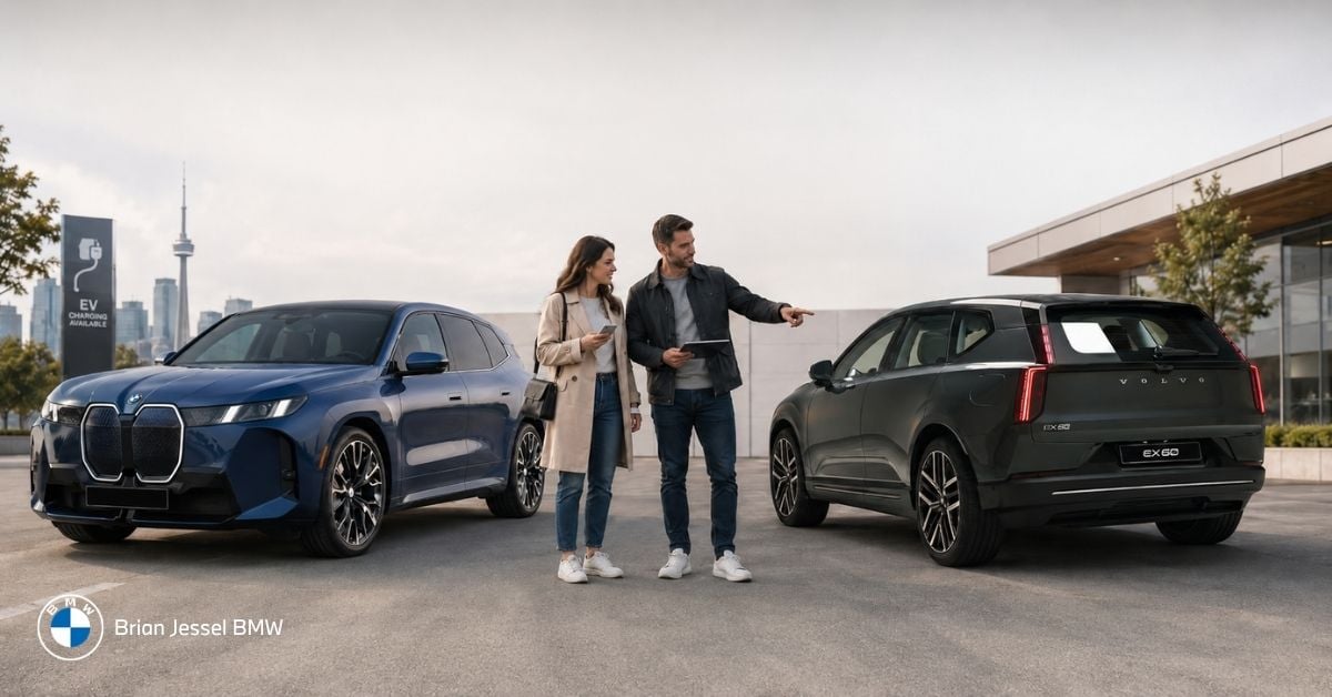 Couple compares two electric SUVs at a Canadian dealership, considering purchase options beside BMW and Volvo models.