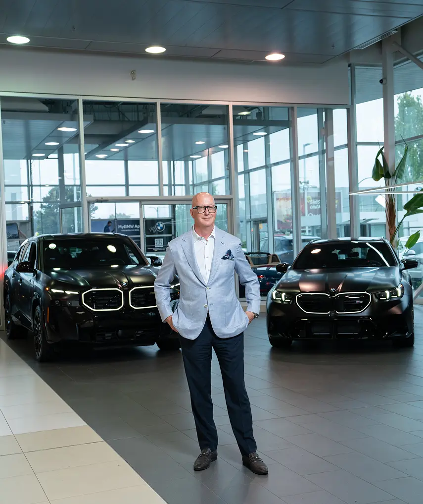 Brian Jessel BMW advisor with BMW XM models in the Vancouver showroom