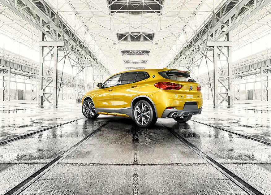 Yellow BMW X2 rear view in a hangar