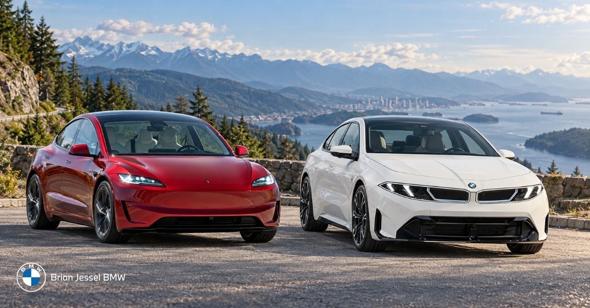 Tesla Model 3 and BMW i3 parked side by side overlooking Vancouver’s scenic mountains and coastline.