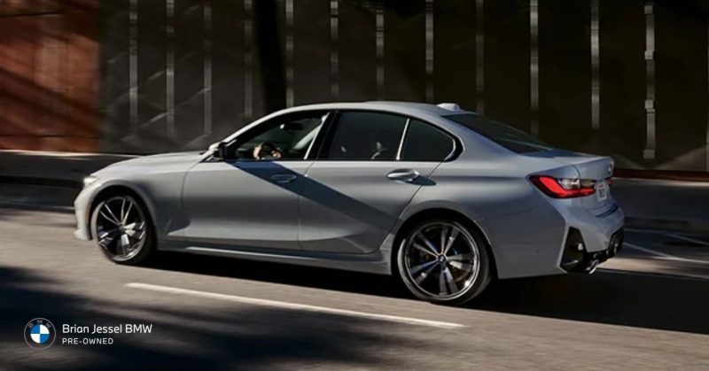 BMW sedan driving in sunlight through the city, sized for comfort, practicality, and everyday lifestyles