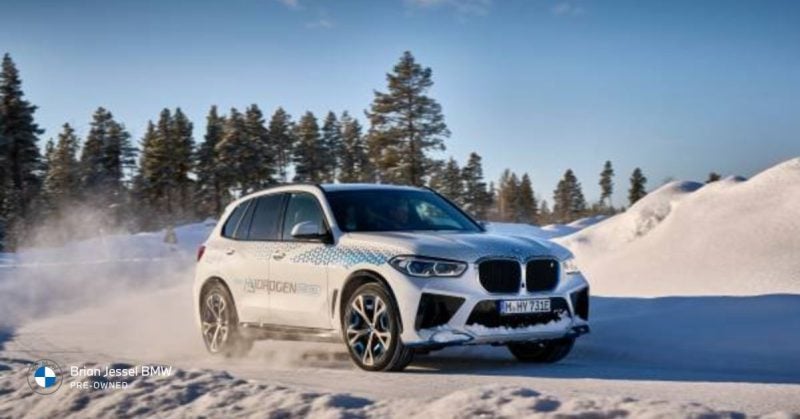 BMW X5 navigating snowy mountain roads with ease.