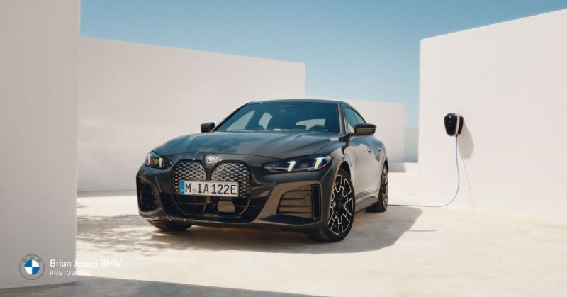 BMW i4 electric sedan charging in a clean, modern setting