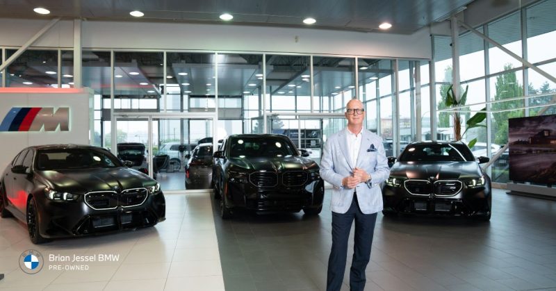 Brian Jessel BMW showroom with sleek black M-series cars and a welcoming staff membe