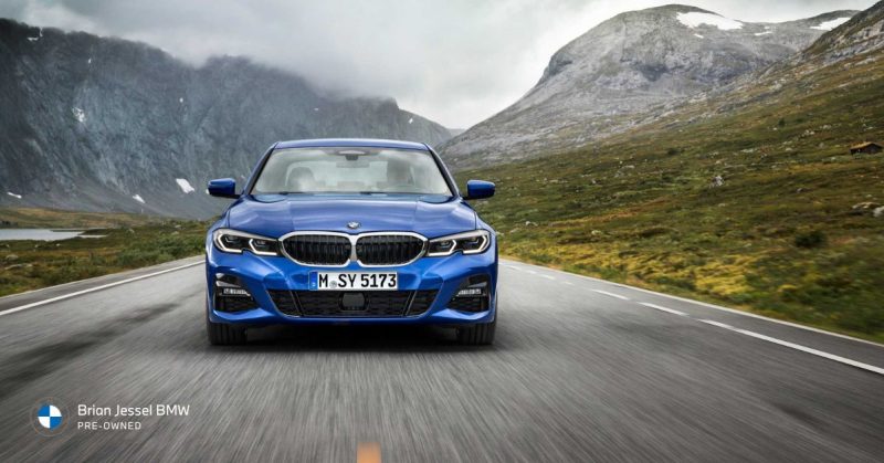 Front view of the BMW 3 Series on a mountain road, showcasing its performance and style