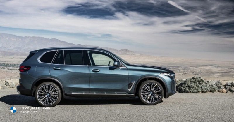 BMW X5 parked on a scenic mountain road, showcasing its sleek design and premium performance
