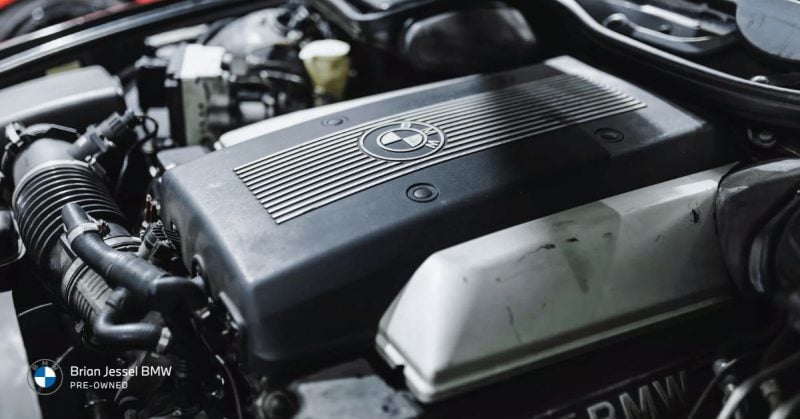 Close-up of BMW engine with detailed components, showcasing the performance and maintenance care required