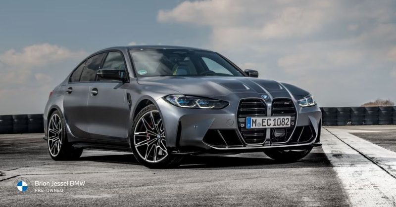 2022 BMW M3 Competition xDrive grey sedan on track, highlighting all-wheel drive grip, sharp handling, and performance design