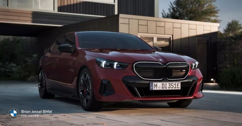 2024 BMW i5 M60 xDrive electric sedan parked outside modern home, showcasing sleek design, dual motor performance, and luxury styling