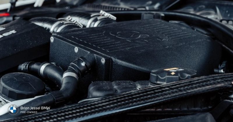 BMW engine bay highlighting Condition Based Service (CBS) for recommended maintenance intervals