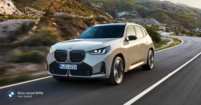 White BMW X3 SUV driving on winding mountain highway, showcasing spacious luxury, confident handling, and versatile family practicality daily.
