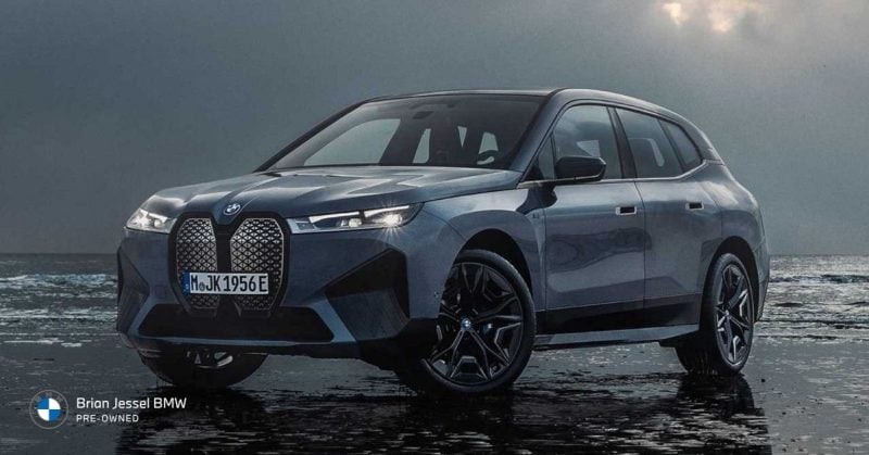 2023 BMW iX electric luxury SUV parked beside water, showcasing spacious design, premium comfort, and long-range EV capability.