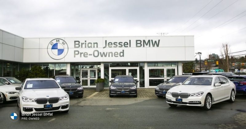 Exterior view of Brian Jessel BMW Pre-Owned dealership with multiple BMW vehicles displayed outside Vancouver showroom location.