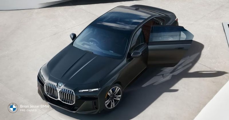 2024 BMW i7 luxury electric sedan with open door, highlighting premium design and used EV value in 2026.