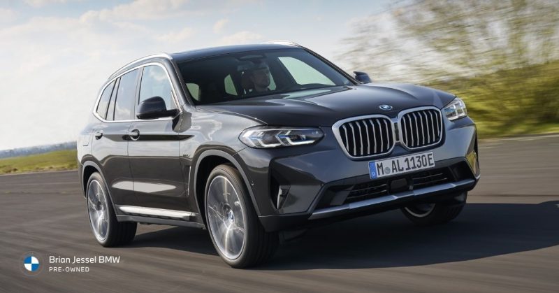 2024 BMW X3 luxury SUV driving on highway, highlighting xDrive capability, practicality, comfort, and versatile pre-owned performance appeal.