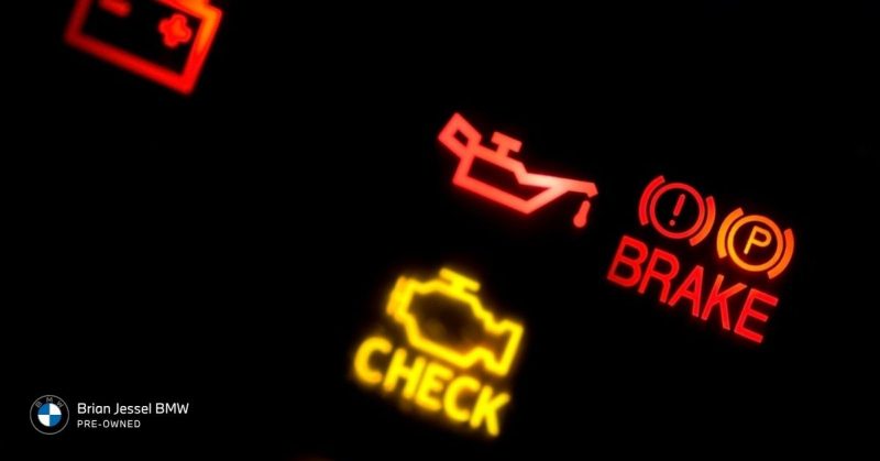 BMW dashboard warning lights displaying check engine, oil pressure, and brake alerts indicating potential serious engine problems ahead.
