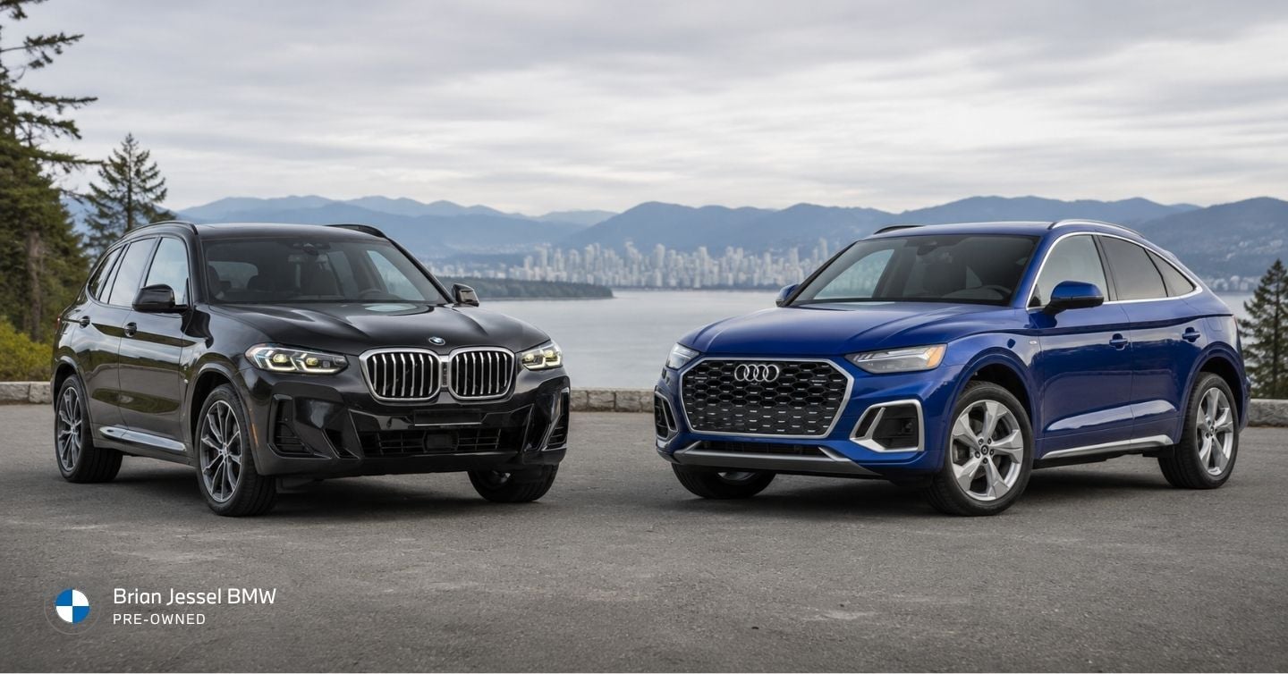 2023 BMW X3 and Audi Q5 luxury SUVs parked side by side overlooking Vancouver’s scenic waterfront and mountains.