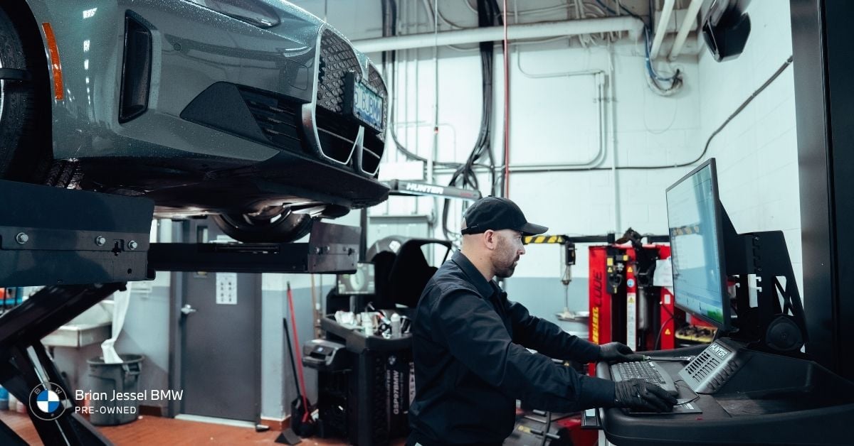 BMW certified technician uses diagnostic equipment while servicing a BMW vehicle at Brian Jessel BMW Pre-Owned.