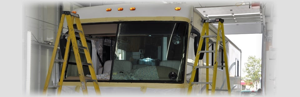 RV in the bodyshop with work ladders around